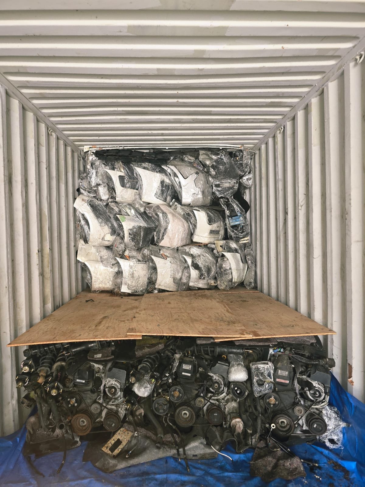 container loaded with car engines and parts